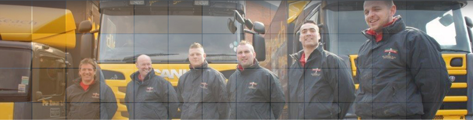 International Removal Service from anywhere in the UK Close up of work colleagues by lorries