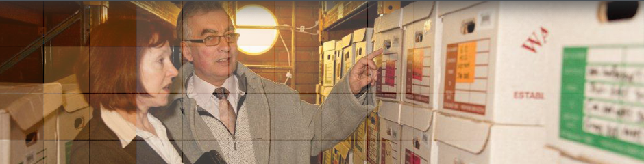 Two people looking through archives in storage